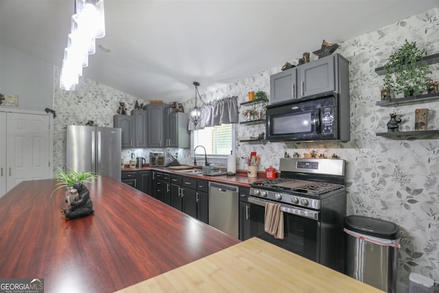 287 Napier Dr, Eatonton, GA 31024 - kitchen featuring wood counters, stainless steel appliances, a sink, open shelves, and wallpapered walls