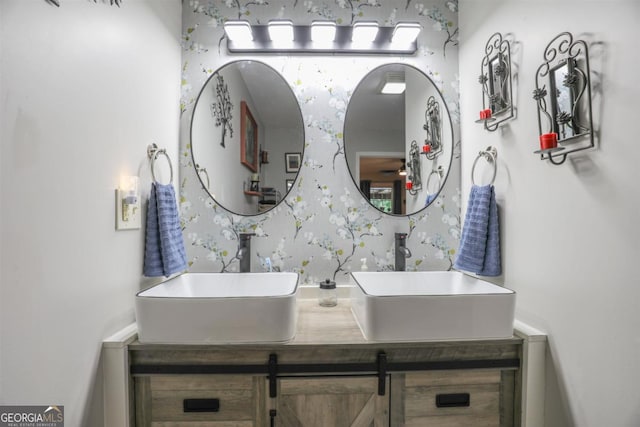 287 Napier Dr, Eatonton, GA 31024 - bathroom featuring wallpapered walls and double vanity