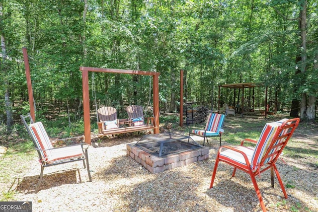 287 Napier Dr, Eatonton, GA 31024 - view of patio featuring a fire pit