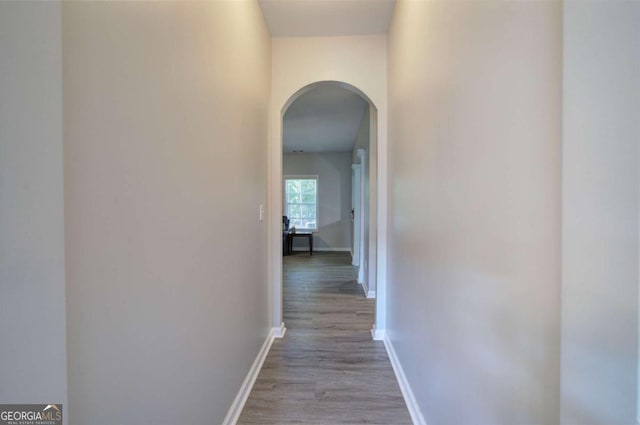 26 Ivey Meadow Dr, Dallas, GA 30132 - hallway with arched walkways, baseboards, and wood finished floors