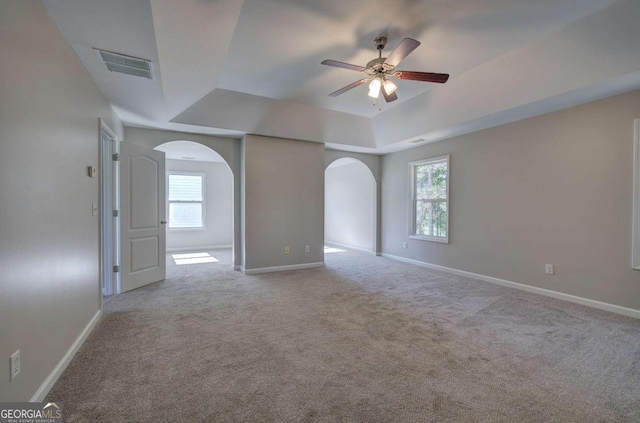 26 Ivey Meadow Dr, Dallas, GA 30132 - spare room with a raised ceiling, arched walkways, a ceiling fan, baseboards, and carpet floors