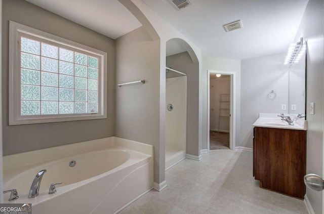 26 Ivey Meadow Dr, Dallas, GA 30132 - bathroom with a bath, a shower stall, vanity, baseboards, and a walk in closet