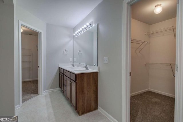 26 Ivey Meadow Dr, Dallas, GA 30132 - bathroom with double vanity, baseboards, and a spacious closet