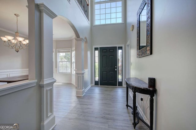 26 Ivey Meadow Dr, Dallas, GA 30132 - entrance foyer with arched walkways, wood finished floors, ornamental molding, decorative columns, and a high ceiling