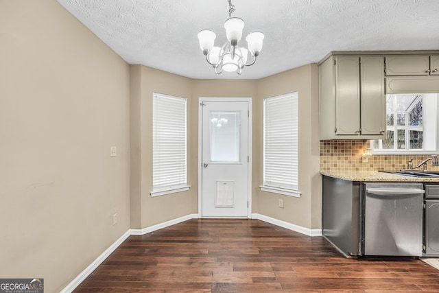 130 Nicki Ct, Hampton, GA 30228 - kitchen featuring stainless steel dishwasher, a chandelier, dark wood finished floors, tasteful backsplash, and baseboards