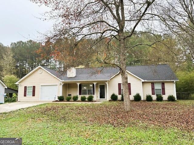 130 Nicki Ct, Hampton, GA 30228 - ranch-style home with an attached garage, concrete driveway, a chimney, and a front yard