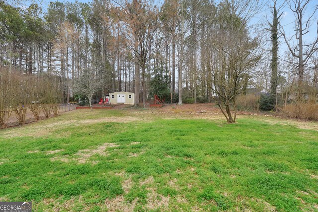 130 Nicki Ct, Hampton, GA 30228 - view of yard featuring an outbuilding and view of wooded area