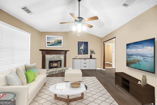 130 Nicki Ct, Hampton, GA 30228 - living room featuring wood finished floors, ceiling fan, lofted ceiling, a premium fireplace, and baseboards
