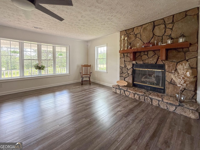 712 Boy Scout Rd, Newnan, GA 30263 - unfurnished living room with a textured ceiling, a fireplace, baseboards, wood finished floors, and ceiling fan