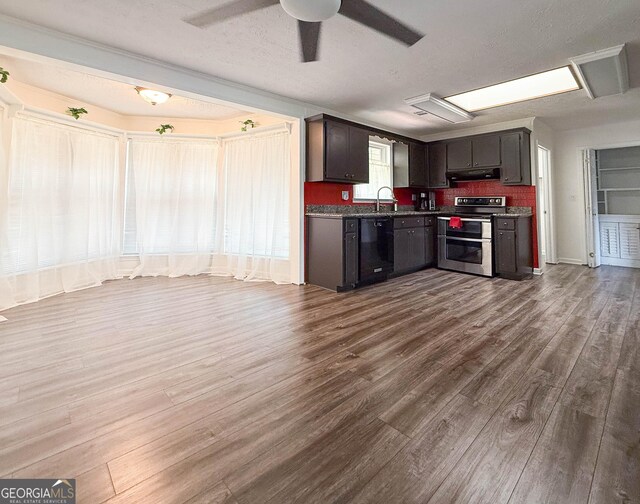 712 Boy Scout Rd, Newnan, GA 30263 - kitchen with range with two ovens, black dishwasher, exhaust hood, dark wood-style floors, and a ceiling fan
