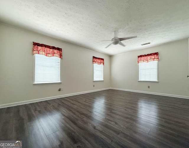 712 Boy Scout Rd, Newnan, GA 30263 - spare room with a textured ceiling, a ceiling fan, dark wood-style floors, and baseboards