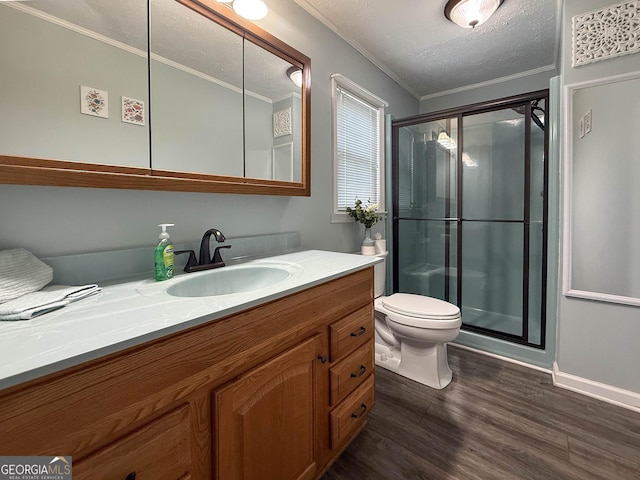 712 Boy Scout Rd, Newnan, GA 30263 - bathroom featuring vanity, a stall shower, wood finished floors, ornamental molding, and toilet
