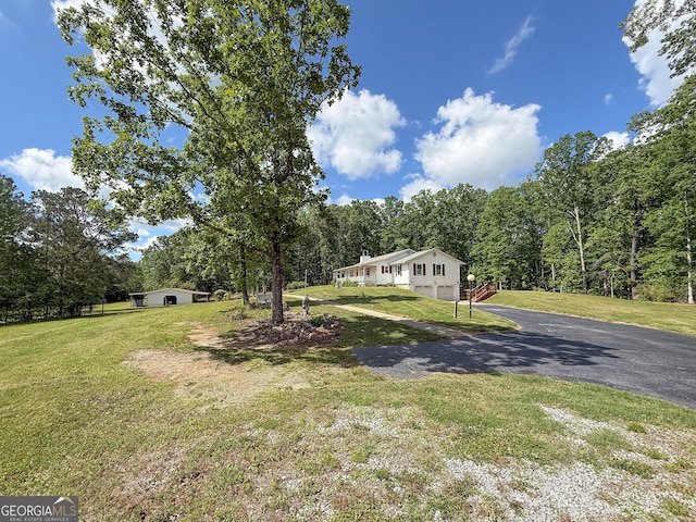 712 Boy Scout Rd, Newnan, GA 30263 - manufactured / mobile home featuring driveway, a front yard, and a view of trees