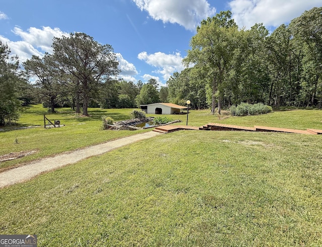 712 Boy Scout Rd, Newnan, GA 30263 - surrounding community featuring a lawn and a wooden deck