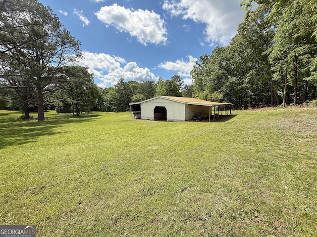 712 Boy Scout Rd, Newnan, GA 30263 - view of grassy yard with a pole building and an outdoor structure