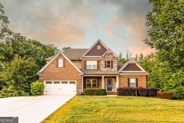 632 Creekside Trce, Covington, GA 30014 - craftsman-style house featuring a garage, driveway, stone siding, covered porch, and brick siding