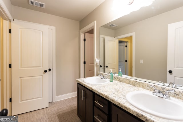 632 Creekside Trce, Covington, GA 30014 - full bath featuring double vanity, wood finished floors, and baseboards