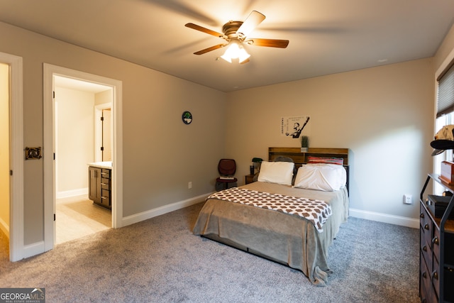 632 Creekside Trce, Covington, GA 30014 - bedroom featuring light colored carpet, baseboards, ceiling fan, and connected bathroom
