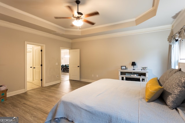 632 Creekside Trce, Covington, GA 30014 - bedroom with a raised ceiling, wood finished floors, ornamental molding, baseboards, and a ceiling fan