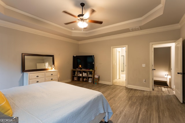 632 Creekside Trce, Covington, GA 30014 - bedroom featuring a raised ceiling, dark wood-style floors, crown molding, baseboards, and a ceiling fan