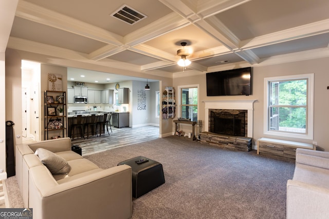 632 Creekside Trce, Covington, GA 30014 - living room featuring healthy amount of natural light, a ceiling fan, a stone fireplace, beamed ceiling, and coffered ceiling