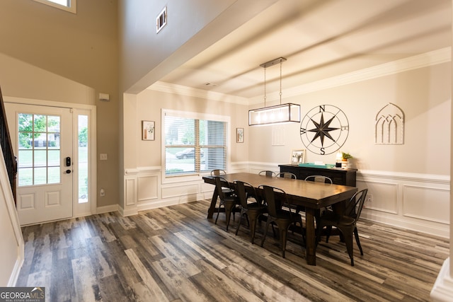 632 Creekside Trce, Covington, GA 30014 - dining space featuring dark wood-style flooring, a decorative wall, ornamental molding, and a wainscoted wall