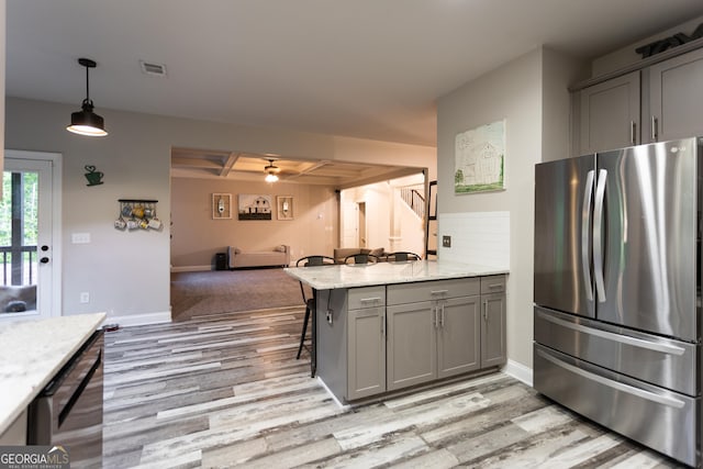 632 Creekside Trce, Covington, GA 30014 - kitchen with freestanding refrigerator, gray cabinets, light wood finished floors, open floor plan, and beamed ceiling