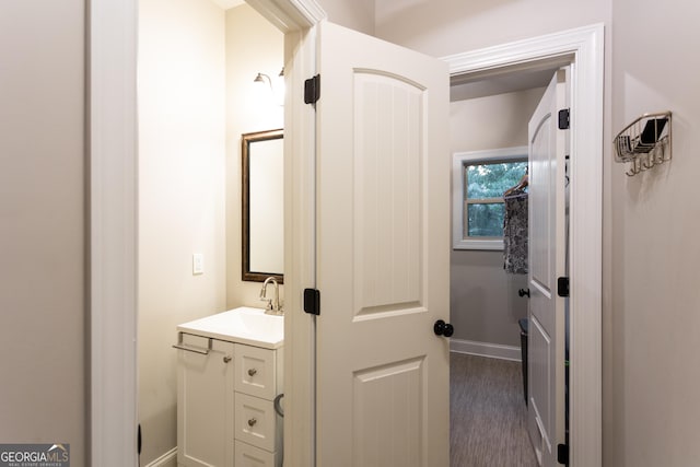 632 Creekside Trce, Covington, GA 30014 - bathroom with vanity, wood finished floors, and baseboards