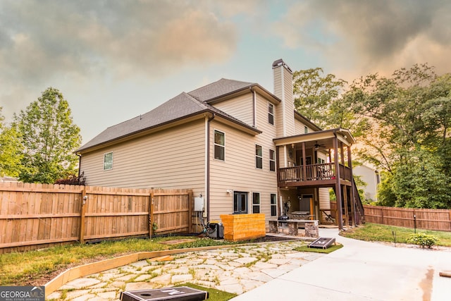 632 Creekside Trce, Covington, GA 30014 - rear view of house featuring a ceiling fan, a chimney, a fenced backyard, and a patio area