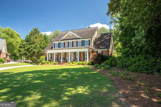 395 Grove Ridge Dr, Loganville, GA 30052 - view of front of property featuring a porch, a front yard, and brick siding