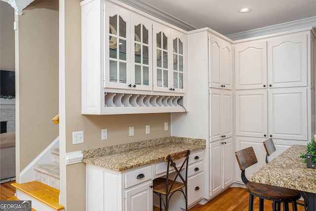 395 Grove Ridge Dr, Loganville, GA 30052 - kitchen featuring light wood-style floors, glass insert cabinets, white cabinetry, and recessed lighting