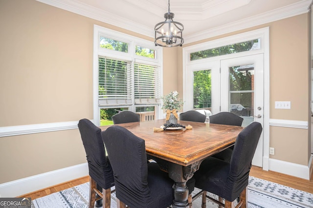 395 Grove Ridge Dr, Loganville, GA 30052 - dining space featuring a chandelier, crown molding, wood finished floors, baseboards, and a tray ceiling