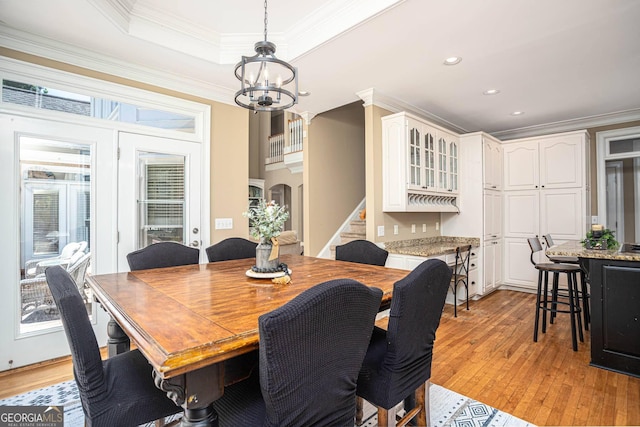395 Grove Ridge Dr, Loganville, GA 30052 - dining room featuring a chandelier, light wood-type flooring, stairway, ornamental molding, and recessed lighting