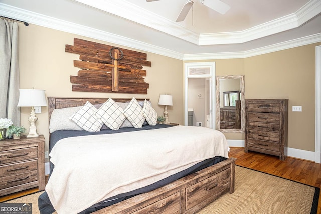 395 Grove Ridge Dr, Loganville, GA 30052 - bedroom with crown molding, a tray ceiling, wood finished floors, and a ceiling fan