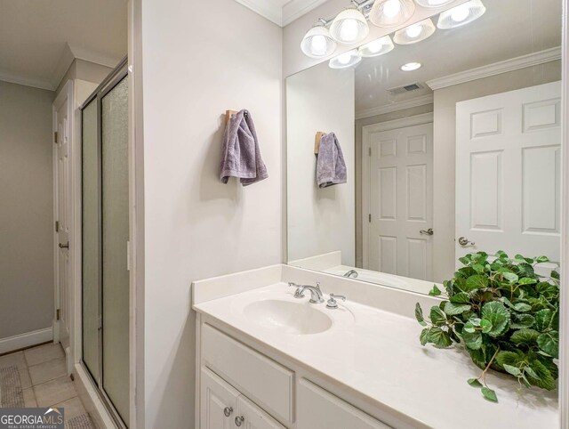 395 Grove Ridge Dr, Loganville, GA 30052 - bathroom featuring ornamental molding, vanity, a stall shower, and tile patterned flooring