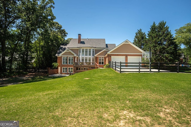 395 Grove Ridge Dr, Loganville, GA 30052 - rear view of house with brick siding, a fenced backyard, a garage, a chimney, and a wooden deck