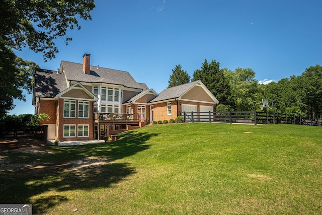 395 Grove Ridge Dr, Loganville, GA 30052 - back of property with brick siding, a chimney, a wooden deck, and a garage