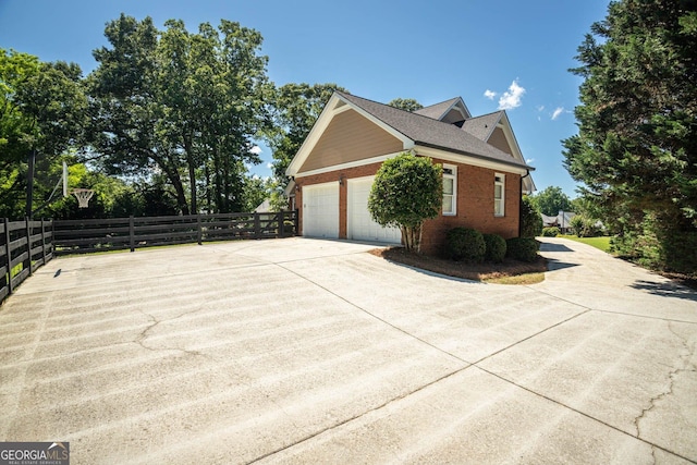 395 Grove Ridge Dr, Loganville, GA 30052 - view of home's exterior featuring concrete driveway, brick siding, and an attached garage
