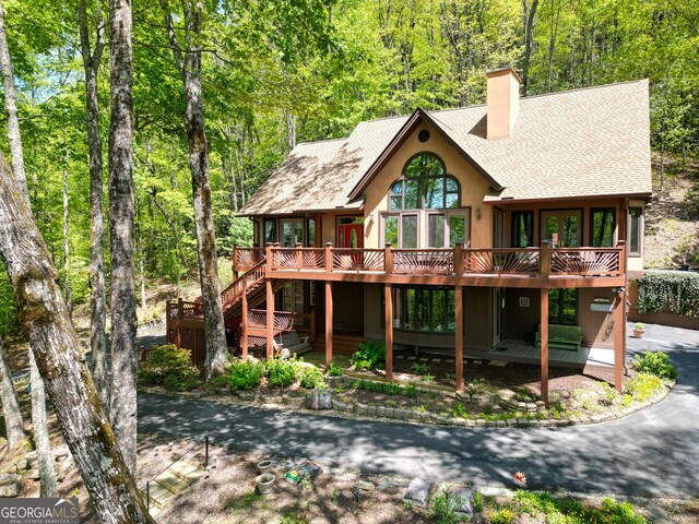 1289 Rainwater Trl, Tiger, GA 30576 - rear view of property with roof with shingles, a chimney, a deck, stucco siding, and stairs