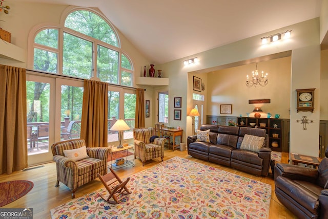 1289 Rainwater Trl, Tiger, GA 30576 - living room featuring high vaulted ceiling, a chandelier, and light wood finished floors