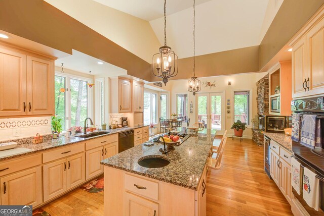 1289 Rainwater Trl, Tiger, GA 30576 - kitchen with a sink, light brown cabinets, dishwasher, decorative backsplash, and lofted ceiling
