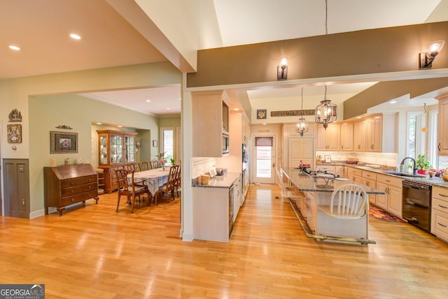1289 Rainwater Trl, Tiger, GA 30576 - kitchen with black dishwasher, a sink, light stone countertops, light wood-type flooring, and an island with sink