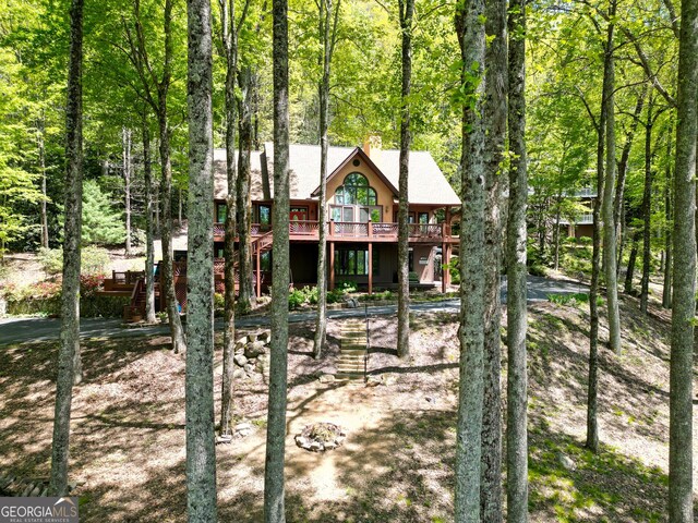 1289 Rainwater Trl, Tiger, GA 30576 - back of property with a deck, stairway, a chimney, and a wooded view