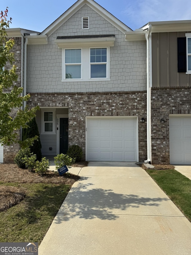 536 Magnolia Cir Unit 116, Palmetto, GA 30268 - townhome / multi-family property with a garage, concrete driveway, brick siding, and board and batten siding