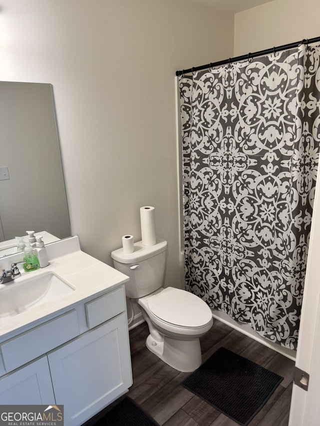 536 Magnolia Cir Unit 116, Palmetto, GA 30268 - full bath with wood finished floors, vanity, toilet, and a shower with curtain