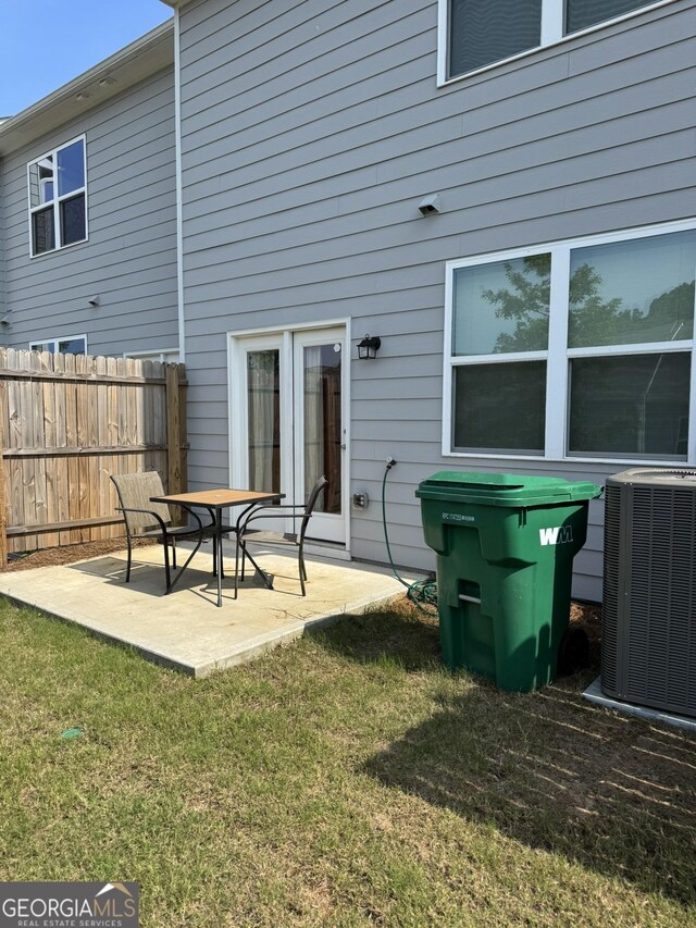 536 Magnolia Cir Unit 116, Palmetto, GA 30268 - back of house with central air condition unit and a patio