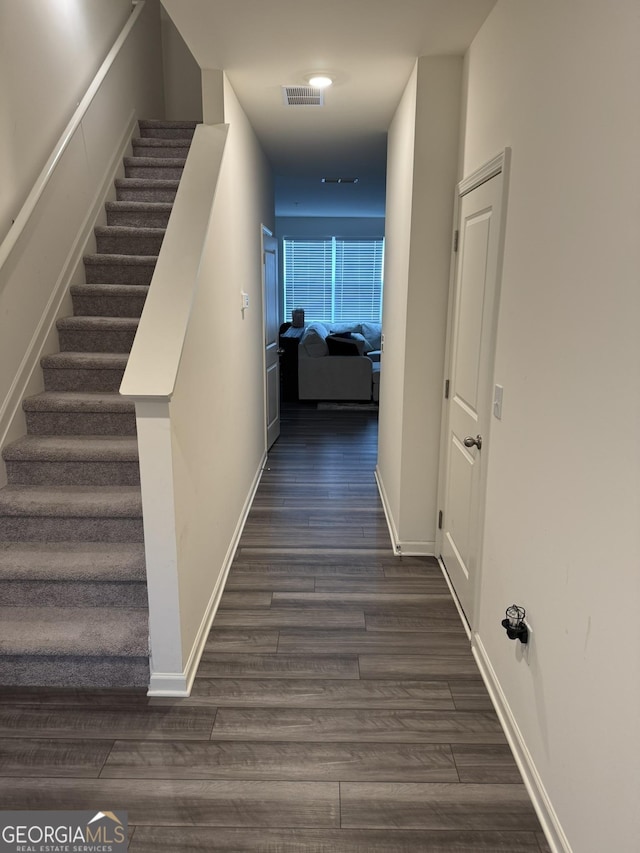 536 Magnolia Cir Unit 116, Palmetto, GA 30268 - hall featuring dark wood finished floors, stairs, and baseboards