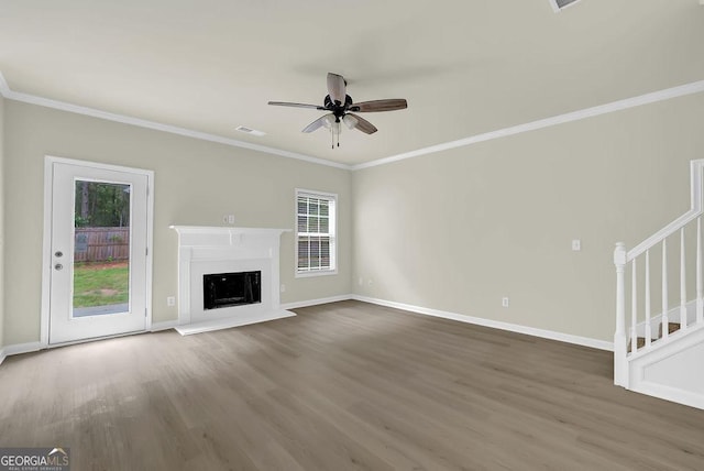 6341 Stewart Ridge Walk, Buford, GA 30518 - unfurnished living room featuring wood finished floors, a ceiling fan, stairs, baseboards, and ornamental molding