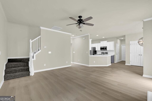 6341 Stewart Ridge Walk, Buford, GA 30518 - unfurnished living room with baseboards, wood finished floors, ceiling fan, stairway, and recessed lighting