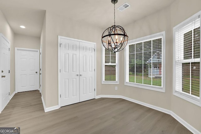 6341 Stewart Ridge Walk, Buford, GA 30518 - unfurnished dining area featuring wood finished floors, a chandelier, and baseboards